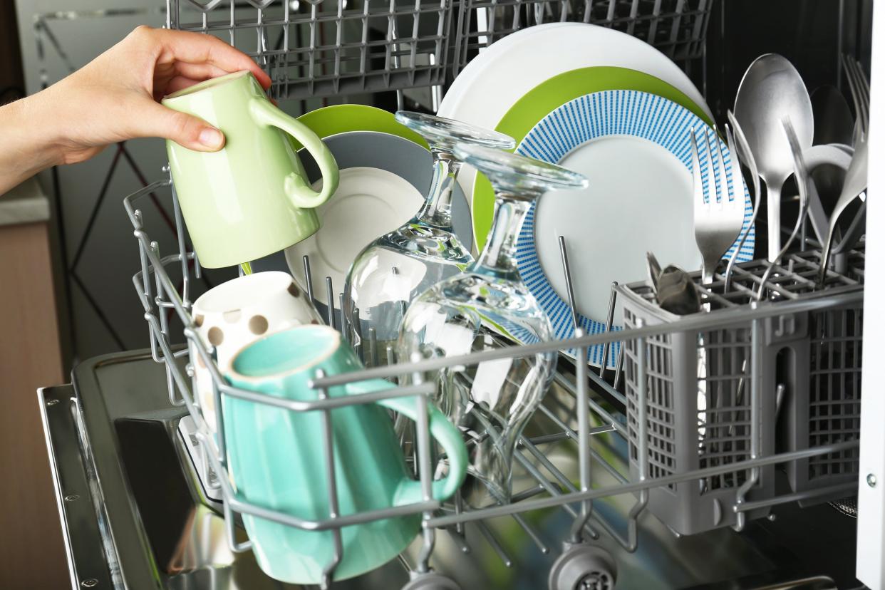 open dishwasher with clean utensils in it