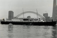 October 21, 1989: The Royal Yacht Britannia sails past the SkyDome to berth at the foot of Sherbourne St. for a six-day stint as home base for the visiting royal couple. (Photo by Boris Spremo/Toronto Star via Getty Images)