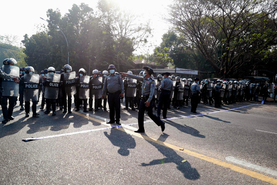 Riot police block the road in front of Yangon University in Yangon, Myanmar on Sunday, Feb. 7, 2021. Thousands of people rallied against the military takeover in Myanmar's biggest city on Sunday and demanded the release of Aung San Suu Kyi, whose elected government was toppled by the army that also imposed an internet blackout. (AP Photo)