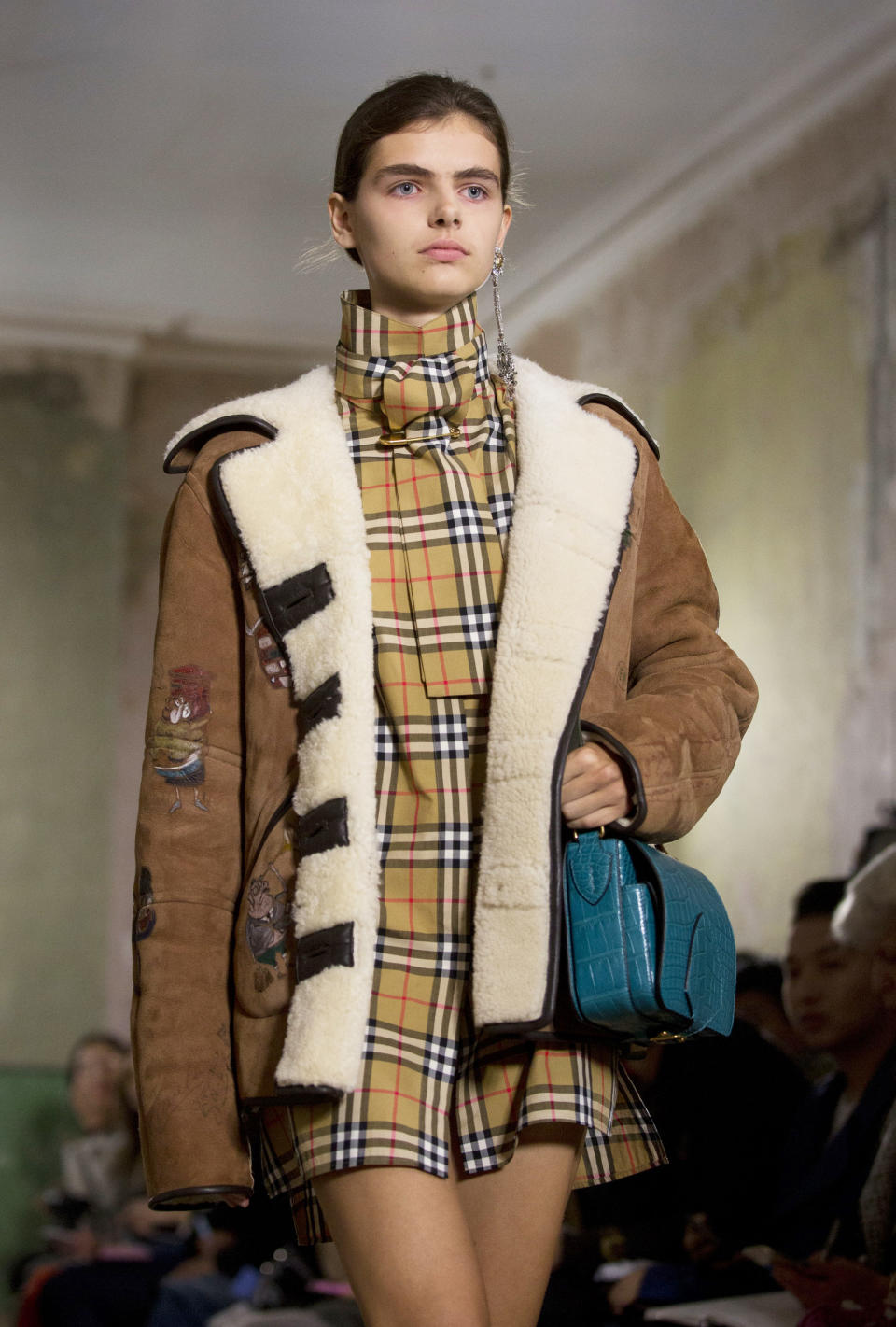 <p>A compact shoulder bag in teal was a favourite accessory at Burberry. <em>[Photo: PA] </em> </p>