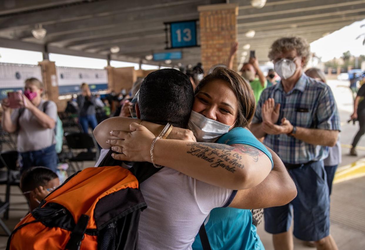<span class="caption">The first group of asylum-seekers allowed to cross from a migrant camp in Mexico into the United States following Biden's repeal of the 'Remain in Mexico' policy arrives to Brownsville, Texas, Feb. 25, 2021.</span> <span class="attribution"><a class="link " href="https://www.gettyimages.com/detail/news-photo/volunteer-welcomes-a-group-of-at-least-25-immigrant-asylum-news-photo/1304097843" rel="nofollow noopener" target="_blank" data-ylk="slk:John Moore/Getty Images;elm:context_link;itc:0;sec:content-canvas">John Moore/Getty Images</a></span>