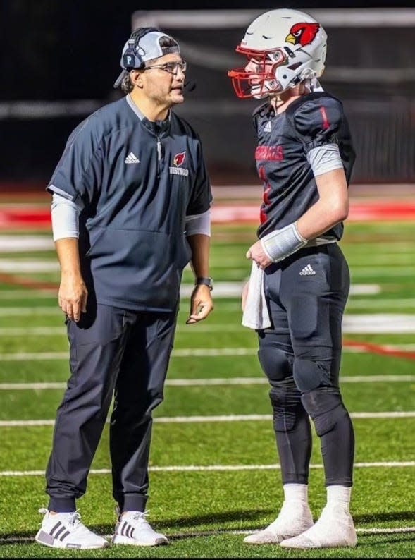 Eddie Suri, left, chats with Westwood QB Robbie Carcich last season. The Cardinals went 13-0 and won the Group 2 title.