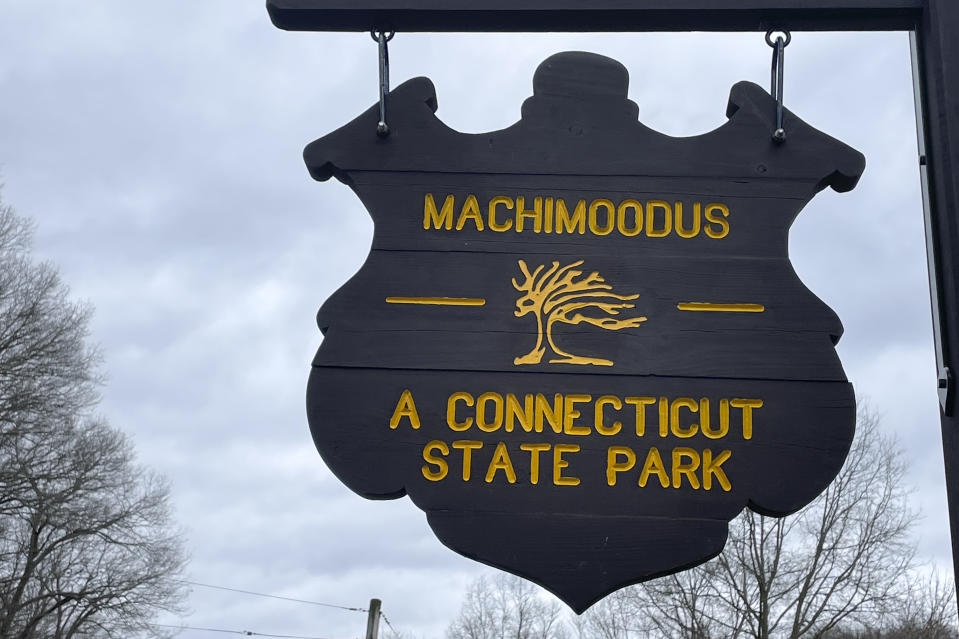 A sign hangs at the entrance to Machimooodus State Park, Thursday, March 7, 2024, in Moodus, Conn. A small earthquake hit the small Connecticut town of East Hampton on Wednesday, but that's nothing new. Seismic sounds known as "The Moodus Noises" have been reported in the East Hampton area and the nearby village of Moodus for centuries. In fact, Moodus is short for Machimoodus or Mackimoodus, which means "place of bad noises" in the Algonquian dialects once spoken in the area. (AP Photo/Pat Eaton-Robb)
