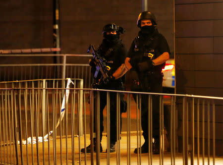 FILE PHOTO: Armed police officers stand next to a police cordon outside the Manchester Arena, where U.S. singer Ariana Grande had been performing, in Manchester, northern England, Britain, May 23, 2017. REUTERS/Andrew Yates/File Photo