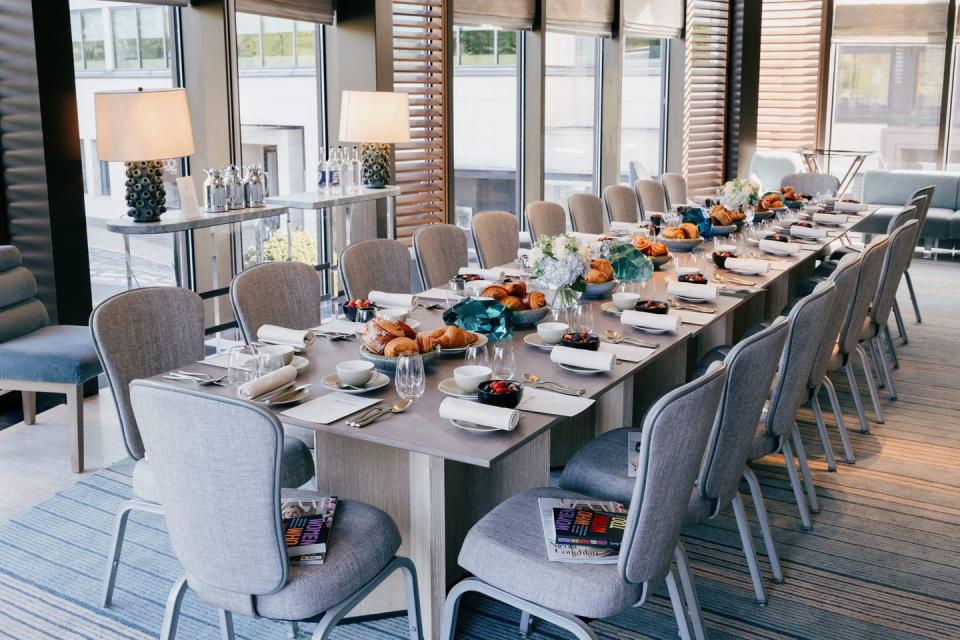 a large dining room table with chairs