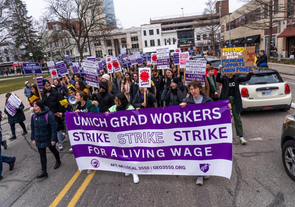 A group marches along South State Street through downtown Ann Arbor as University of Michigan graduate workers along with members of the Graduate Employees Organization and allies march in protest after a rally at The Diag on the campus in Ann Arbor on Wednesday, March 29, 2023, after going on strike.