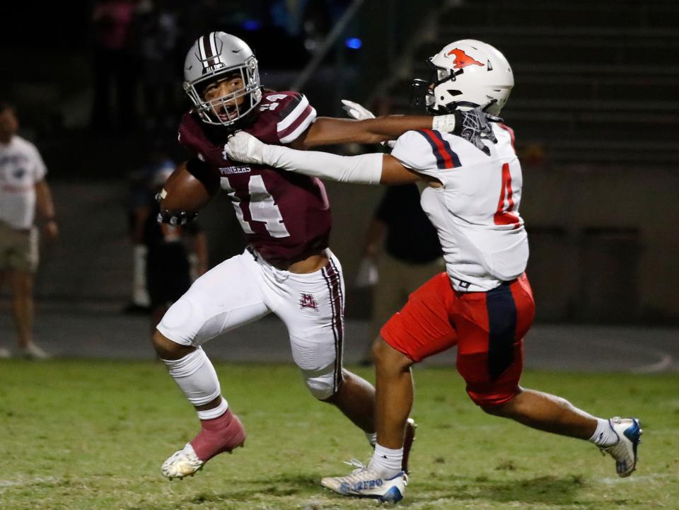 Mt. Whitney's Israel Briggs tries to fend off Tulare Western's Jared Aispuro during their football game at Mineral King Bowl in Visalia, Calif., Friday, Sept. 1, 2023.
