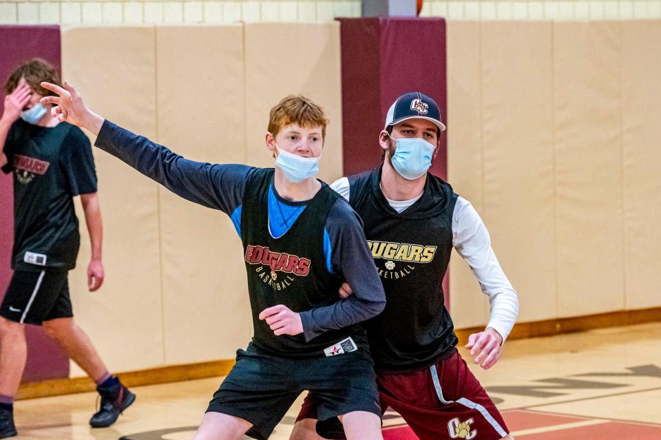 Old Colony assistant coach Jake Jason plays a tough defense on Ryan Scott.