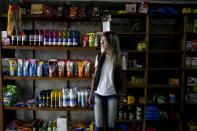 Carla Cavallini poses for a picture inside the grocery store she and her husband opened eight months ago, but that is no longer viable, in Buenos Aires, Argentina, Wednesday, March 6, 2024. Cavallini and her husband are among a large group of Argentines who say their economic situation is worse now than a year ago as a consequence of a series of austerity and deregulation measures ordered by President Javier Milei in his first 100 days in office. (AP Photo/Natacha Pisarenko)