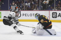 Vancouver Canucks goaltender Spencer Martin (30) stops Los Angeles Kings center Adrian Kempe (9) during the first period of an NHL hockey game Thursday, April 28, 2022, in Vancouver, British Columbia. (Darryl Dyck/The Canadian Press via AP)