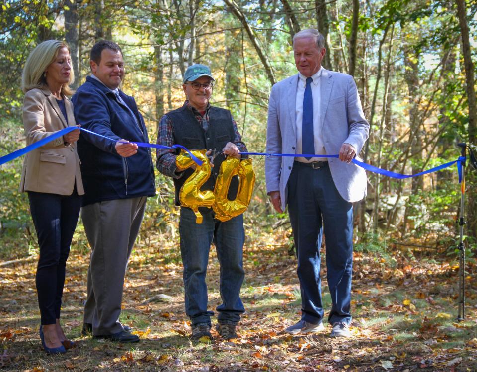 From left, state Rep. Carole Fiola, Fall River Director of Community Utilities Paul Ferland, Water Department forester Michael Labossiere and Mayor Paul Coogan cut a ribbon officially opening the 20-mile Bioreserve Loop Trail in the Southeastern Massachusetts Bioreserve, off Blossom Road, on Wednesday, Oct. 19, 2022.