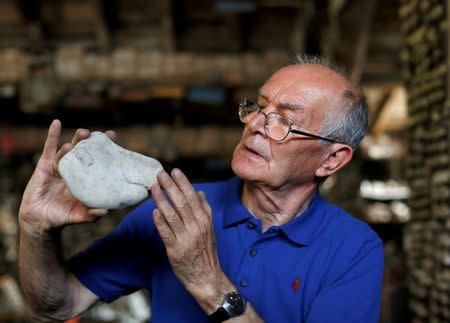 Stone collector Luigi Lineri, 79, cleans a stone found along Adige river, at his home workshop in Zevio, near Verona, Italy, June 10, 2016. REUTERS/Alessandro Bianchi