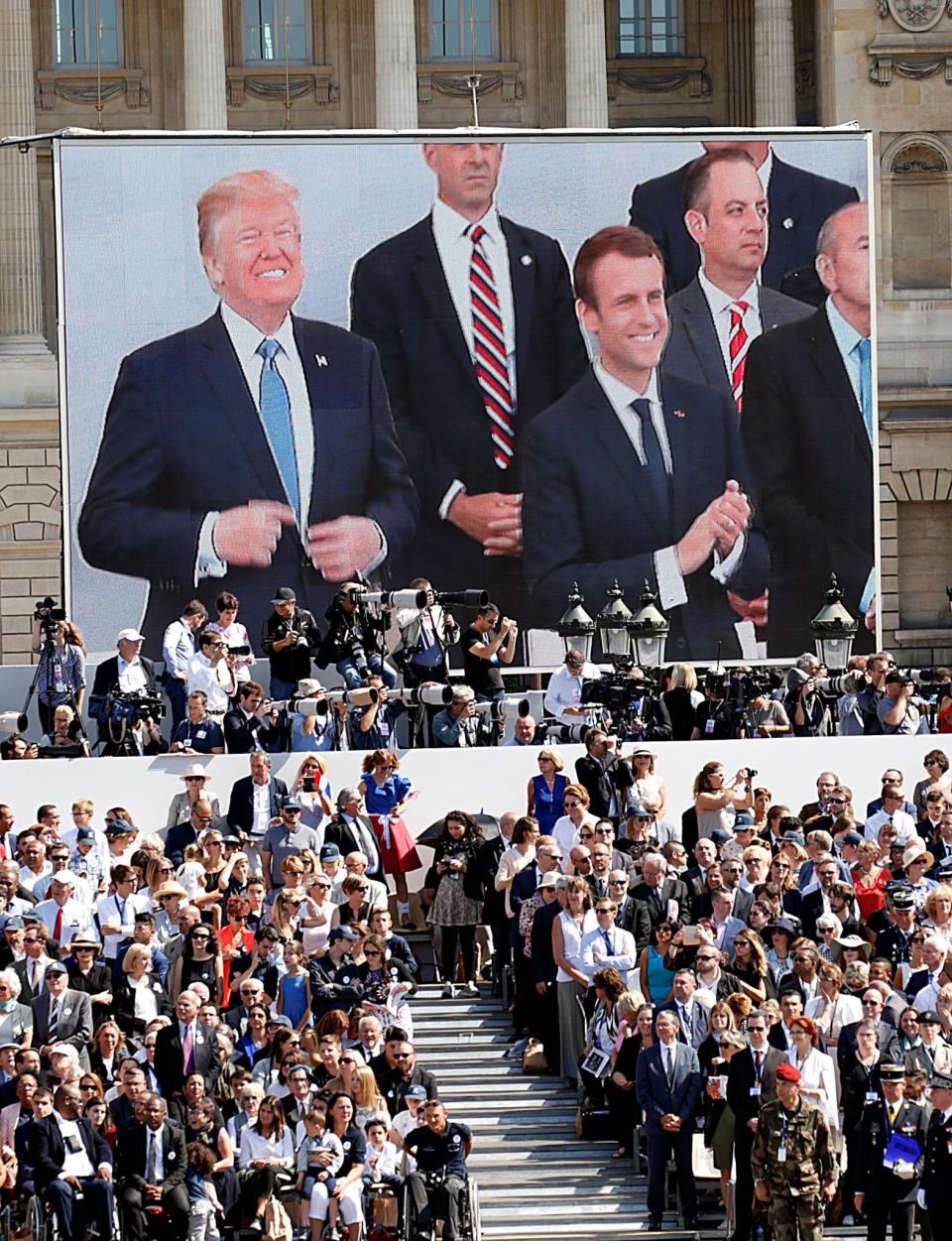 <p>President Donald Trump and French President Emmanuel Macron are seen on a giant screen on the Place de la Concorde as they attend the traditional Bastille Day military parade on the Champs-Elysees in Paris, France, July 14, 2017. (Photo: Kevin Lamarque/Reuters) </p>