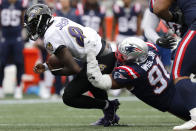 Baltimore Ravens quarterback Lamar Jackson (8) is brought down by New England Patriots defensive end Deatrich Wise Jr. (91) in the first half of an NFL football game, Sunday, Sept. 25, 2022, in Foxborough, Mass. (AP Photo/Paul Connors)