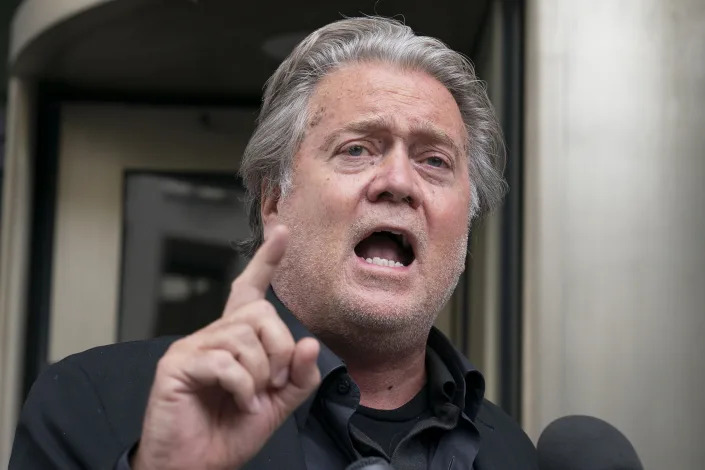 Steve Bannon speaks emphatically, raising his index finger.