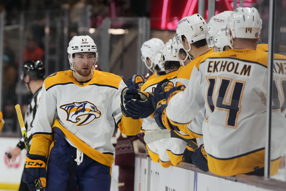 Nashville Predators center Yakov Trenin (13) celebrates with teammates after scoring against the Arizona Coyotes in the first period during an NHL hockey game, Sunday, Feb. 26, 2023, in Tempe, Ariz. (AP Photo/Rick Scuteri)