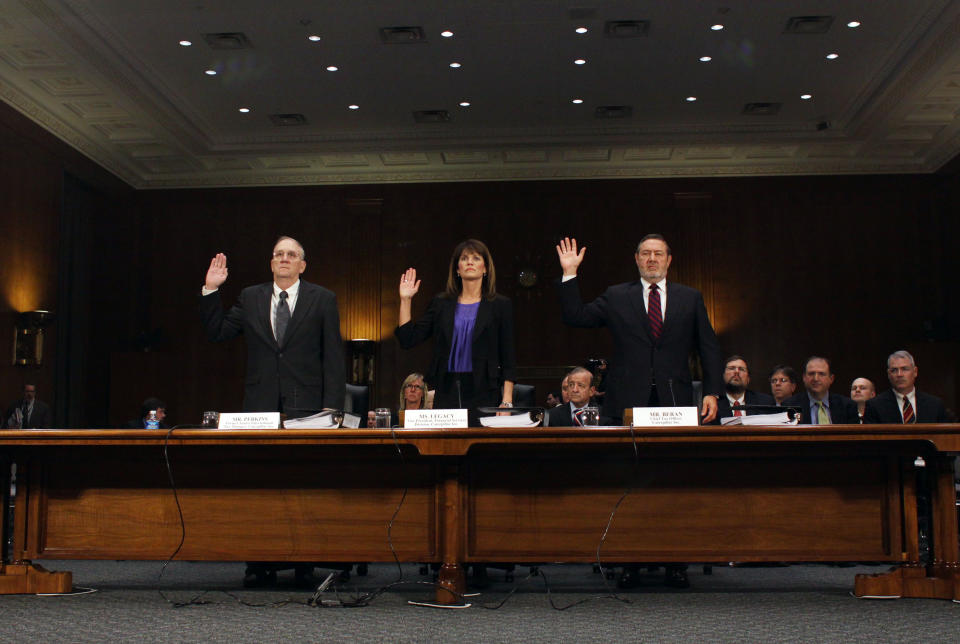 From left, Rodney Perkins, former Senior International Tax Manager for Caterpillar; Julie Lagacy, Vice President, Finance Services Division of Caterpillar;, and Robin Beran, Chief Tax Officer for Caterpillar, are sworn-in on Capitol Hill in Washington, Tuesday, April 1, 2014, prior to testifying before the Senate Permanent subcommittee on Investigations hearing: "Caterpillar's Offshore Tax Strategy. (AP Photo/Lauren Victoria Burke)