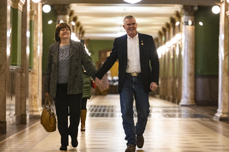 U.S. Rep. Matt Rosendale, R-Mont., walks with his wife Jean Rosendale to file to run for U.S. Senate with the Montana Secretary of State Christi Jacobsen on Friday, Feb. 9, 2024 in the Montana State Capitol in Helena. Rosendale plans to run for U.S. Senate, upending a race in which many national GOP officials already coalesced around a different candidate as they seek to unseat three-term Democrat U.S. Sen. Jon Tester. (Thom Bridge/Independent Record via AP)