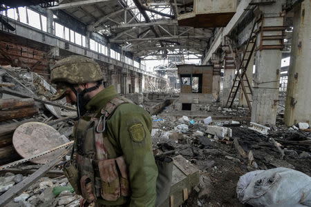 FILE PHOTO: A Ukrainian serviceman guards an area on the front line at the industrial zone of government-held town of Avdiyivka, Ukraine March 7, 2017. REUTERS/Oleksandr Klymenko/File Photo