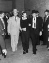 <p>Guards escort Lee Harvey Oswald during a press conference two days after his arrest in conjunction with the assassination of President Kennedy in Dallas, Texas on Nov. 24, 1963. Oswald was shot by local night club owner Jack Ruby during the press conference. (Photo: Corbis via Getty Images) </p>