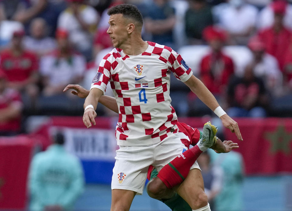 Croatia's Ivan Perisic, top, vies for a ball with Morocco's Achraf Hakimi during the World Cup group F soccer match between Morocco and Croatia, at the Al Bayt Stadium in Al Khor , Qatar, Wednesday, Nov. 23, 2022. (AP Photo/Thanassis Stavrakis)