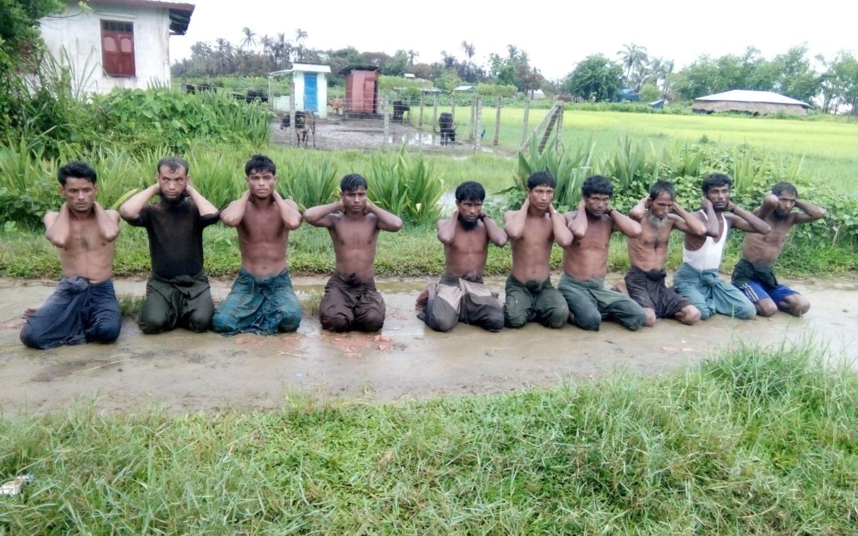 Rohingya Muslim men with their hands bound in Myanmar in 2017 - REUTERS