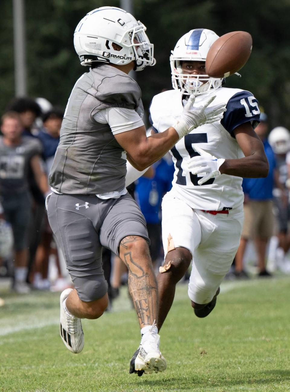Modesto’s Bronson England makes a catch past Santa Rosa’s Solomon Hall and runs in for a touchdown during the game at Modesto Junior College in Modesto, Calif., Saturday, September 9, 2023. Modesto won the game 51-41.