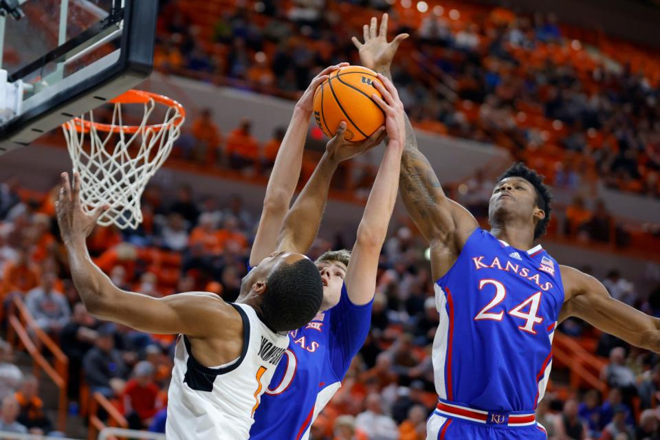 Kansas guard Johnny Furphy (10) blocks the shot of OSU guard Bryce Thompson (1) beside Kansas forward K.J. Adams Jr. (24) on Tuesday night at Gallagher-Iba Arena in Stillwater.