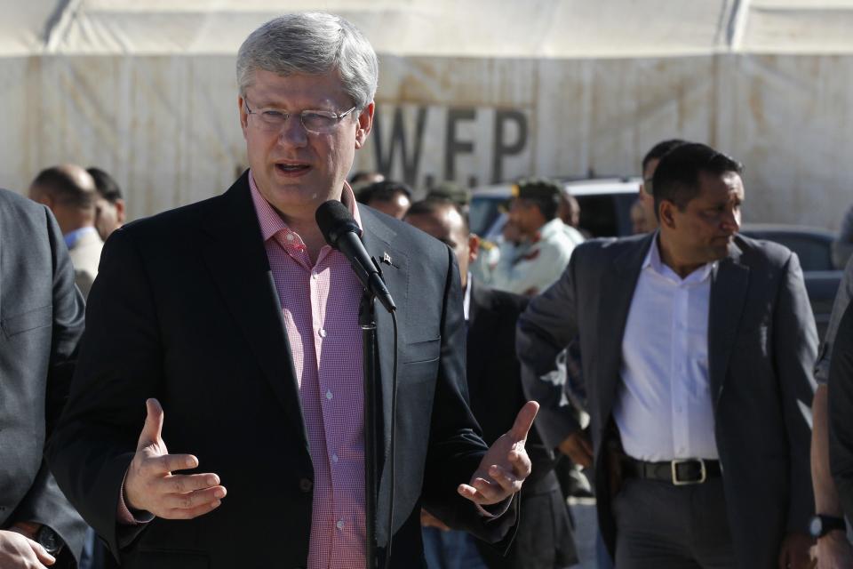 Prime Minister Stephen Harper speaks to the media after his tour in the main center of the World Food Program with his wife Laureen during their visit to Al Zaatari refugee camp, in the Jordanian city of Mafraq, near the border with Syria January 24, 2014. REUTERS/Muhammad Hamed