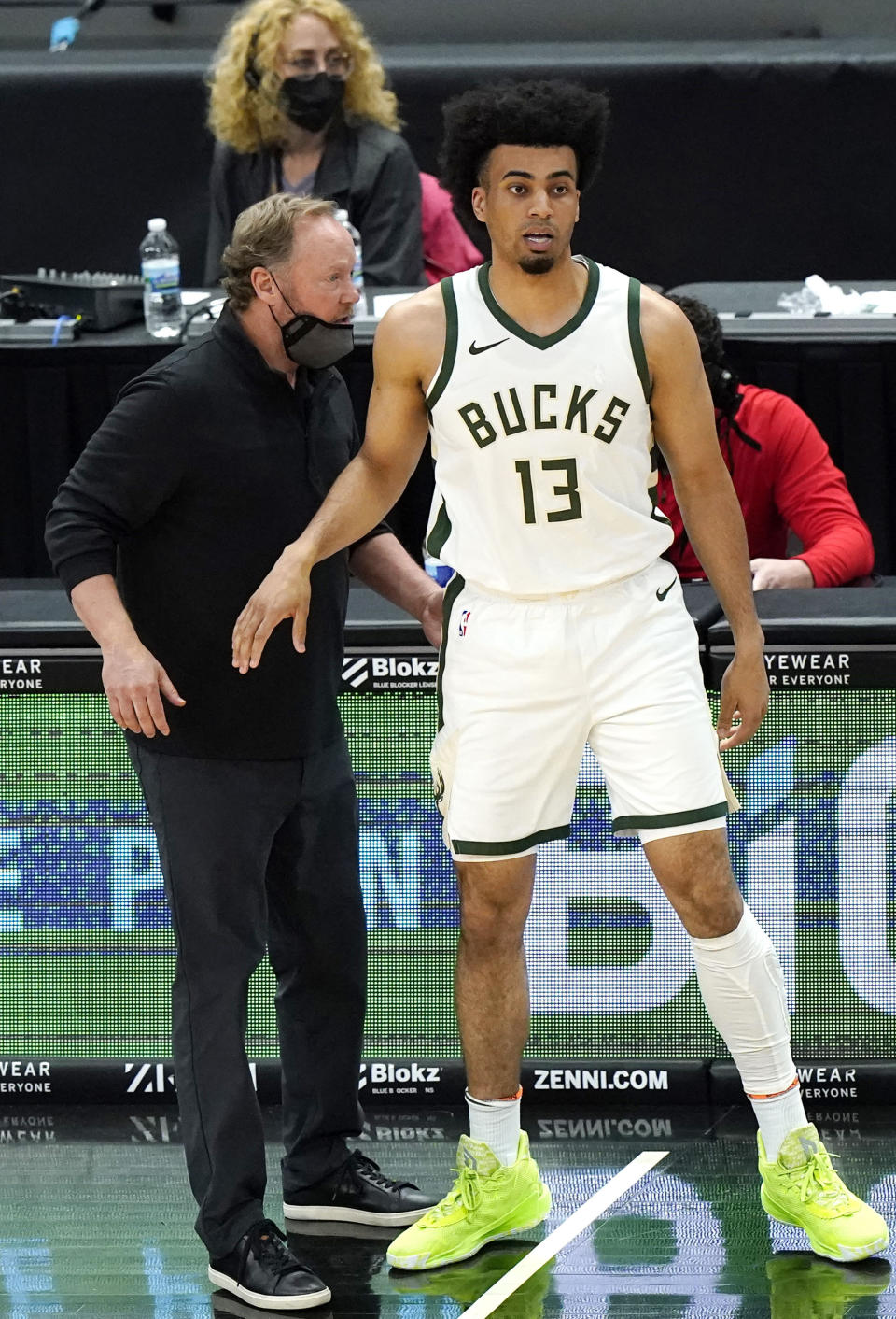 Milwaukee Bucks head coach Mike Budenholzer, left, talks with forward Jordan Nwora during the first half of an NBA basketball game against the Chicago Bulls in Chicago, Friday, April 30, 2021. (AP Photo/Nam Y. Huh)