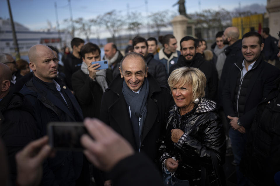 Hard-right political talk-show star Eric Zemmour takes a picture with a fan outside of the Major Cathedral in Marseille, southern France, Saturday, Nov. 27, 2021. The first French presidential ballot will take place next year on April 10 and the two top candidates go into a runoff on April 24. (AP Photo/Daniel Cole)