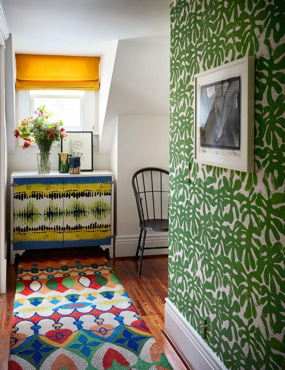 A vibrant rug lines a corridor. Custom cabinet by RP Miller painted by Monica Mahoney; Paper Mills wall covering