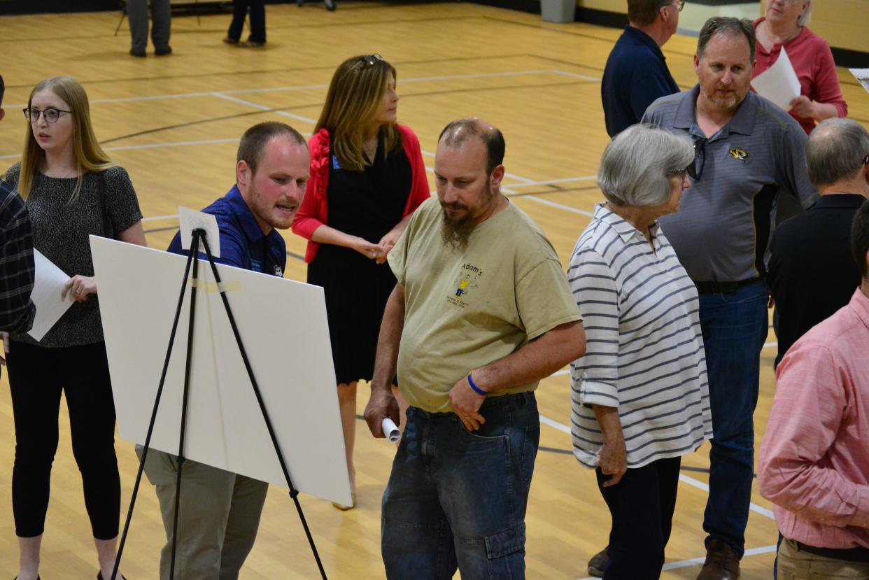 U.S. Highway 63/Grindstone Parkway interchange project manager Zach Osman, second from left, explains proposed project plans to the public Thursday evening at New Haven Elementary School. Changes to the east side of the interchange will go out for bid in fall 2023.