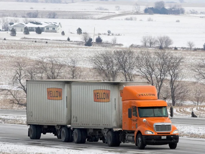 In this Jan. 27, 2009 file photo, a truck bearing the Yellow brand, one of several owned by YRC Worldwide Inc., travels in winter weather.