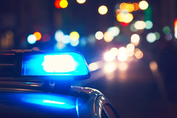 A police car with its lights on at night.