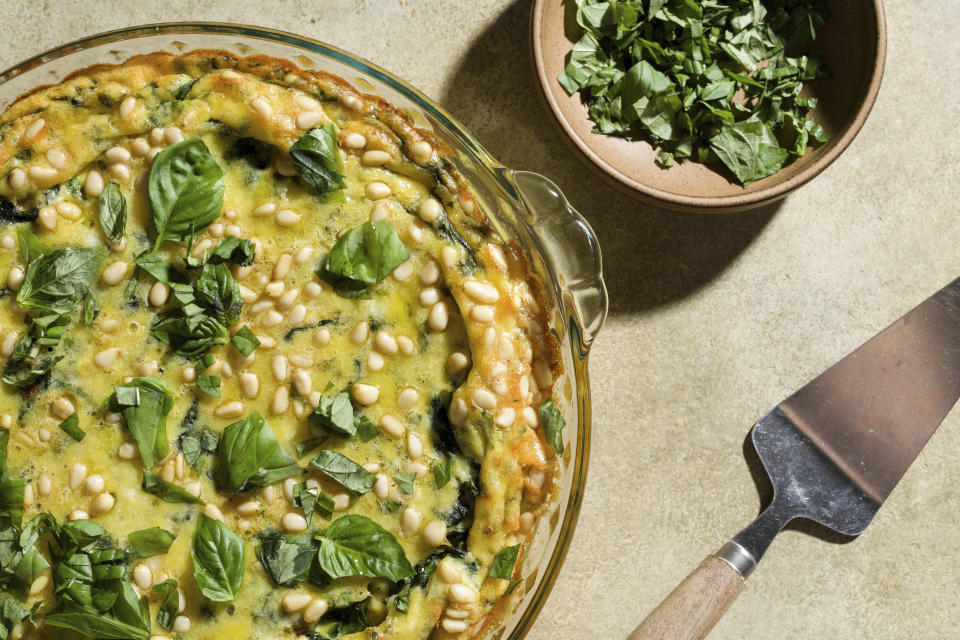 This image released by Milk Street shows a recipe for Baked Eggs with Potatoes and Spinach. (Milk Street via AP)