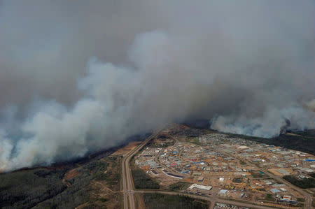 FILE PHOTO -- A Canadian Joint Operations Command aerial photo shows wildfires near neighborhoods in Fort McMurray, Alberta, Canada in this image posted on twitter May 5, 2016. Courtesy CF Operations/Handout via REUTERS