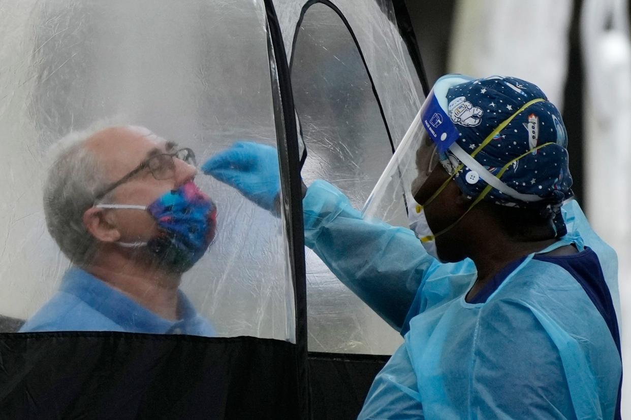 A man is tested for COVID-19 at a walk-up testing site on Tuesday in Miami.