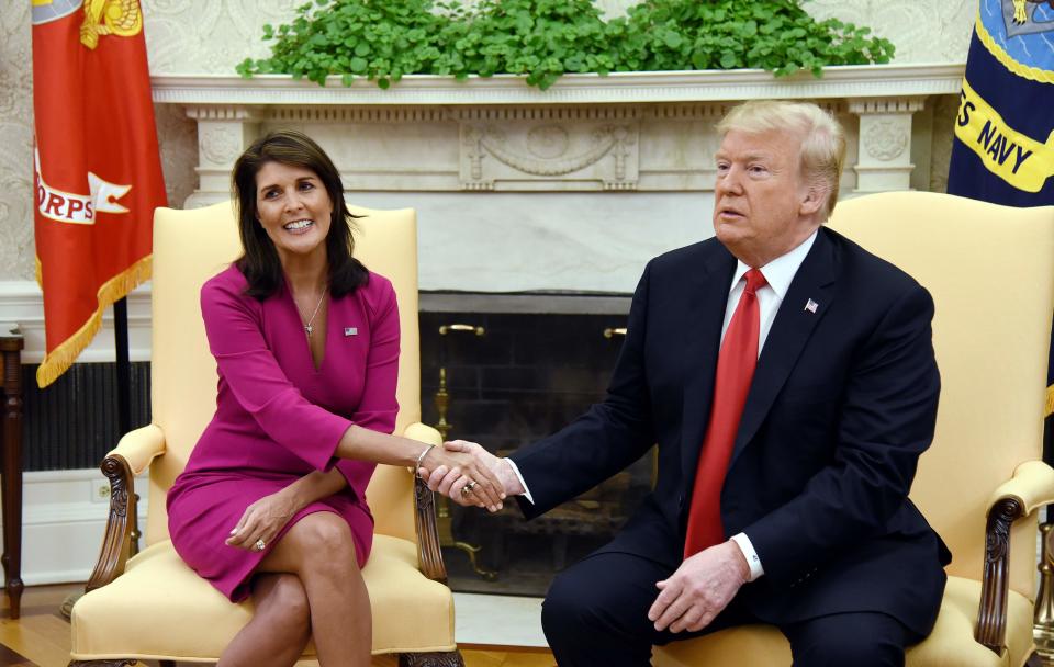 President Trump shakes hands with Nikki Haley, the United States Ambassador to the United Nations in the Oval Office of the White House on Oct. 9, 2018, in Washington.