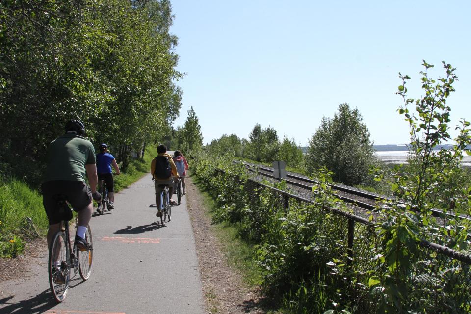 This photo taken June 11, 2013, shows people using the Tony Knowles Coastal Trail in downtown, Anchorage, Alaska. Anchorage offers more than 135 miles of multi-use trails in the city. (AP Photo/Mark Thiessen)