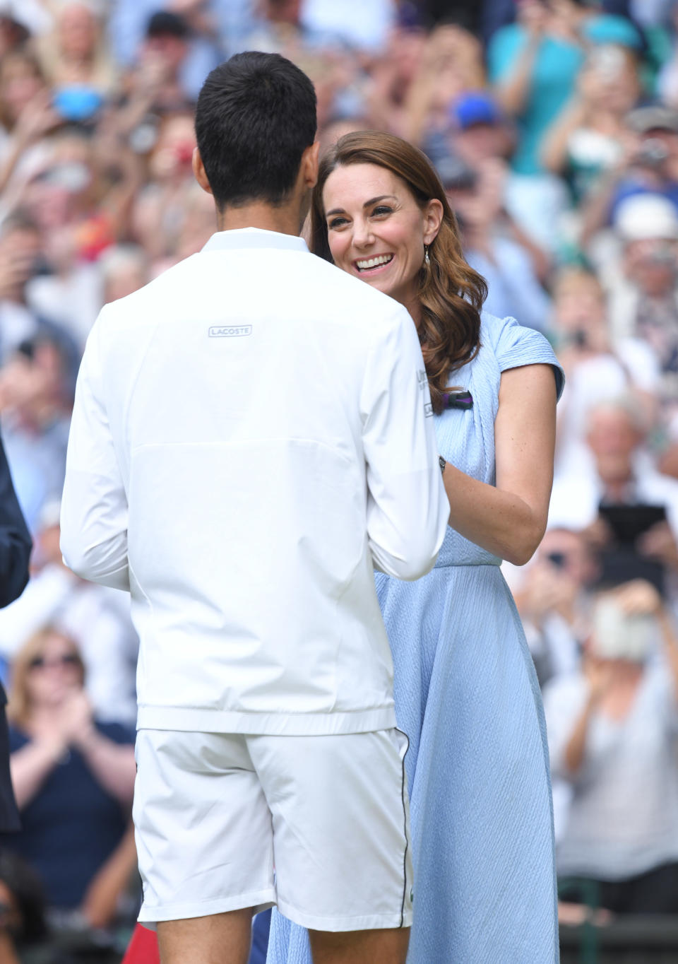 LONDON, ENGLAND - JULY 14: Catherine, Duchess of Cambridge presents Novak Djokovic with the winner's trophy after winning his Men's Singles final against Roger Federer of Switzerland during Day thirteen of the Wimbledon Tennis Championships at All England Lawn Tennis and Croquet Club on July 14, 2019 in London, England. (Photo by Karwai Tang/Getty Images)