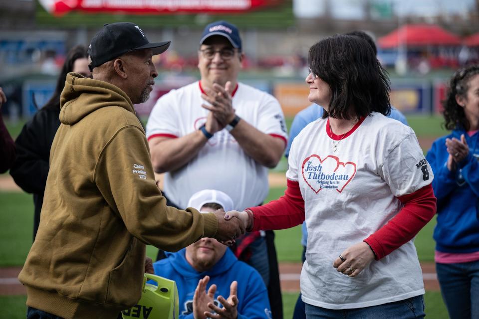 Chance Brown receives an automated external defibrillator machine on behalf of Ted Williams Little League from Deb Thibodeau at Polar Park on Friday April 19, 2024. Thibodeau tragically lost her son Josh to cardiac arrest during a soccer camp in 2011.