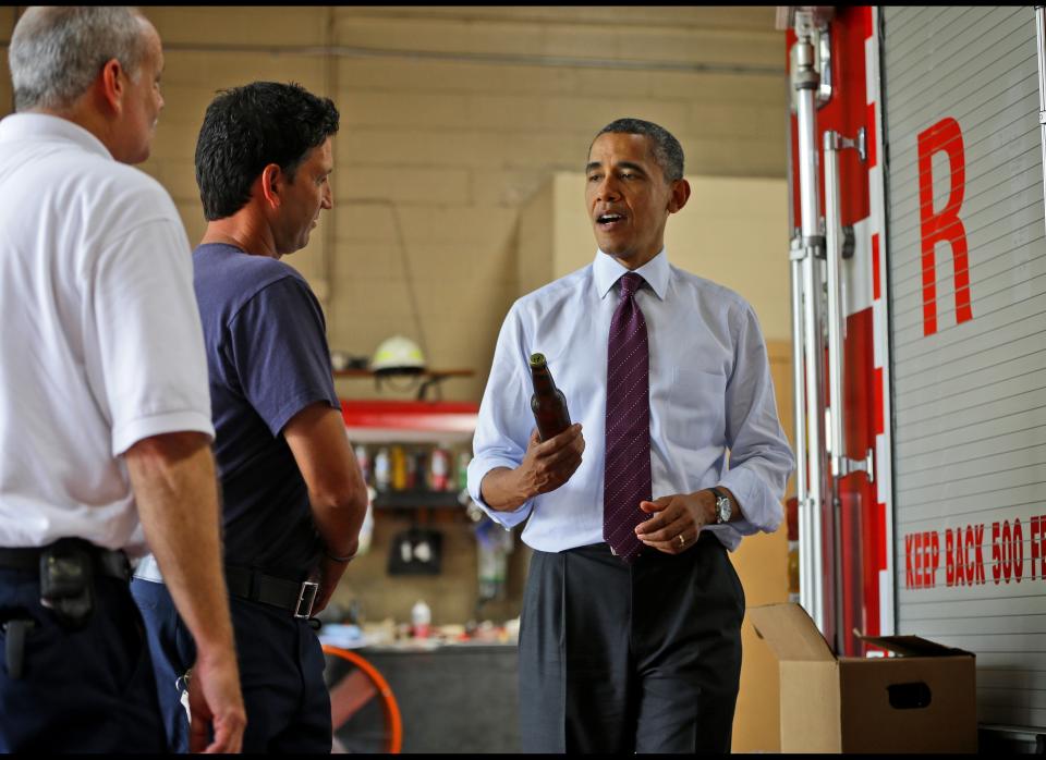 Obama holds up a bottle of beer as he delivers a case of White House brewed beer to the fire fighters at Fire Station No. 14, during an unscheduled stop, Tuesday, Sept. 4, 2012, in Norfolk, Va. (AP Photo/Pablo Martinez Monsivais)