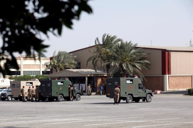 Military officers stand near parked ambulances at the premises of the Expo Center, after government declared it a mass isolation center and field hospital following an outbreak of the coronavirus disease (COVID-19), in Karachi
