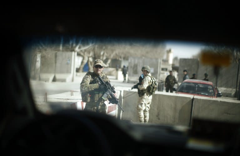 Security personnel patrol as a media vehicle travelling with US Defense Secretary Chuck Hagel leaves a military compound in Kabul on March 9, 2013. Hagel arrived in the Afghan capital as the international military coalition prepares to pull out by the end of next year