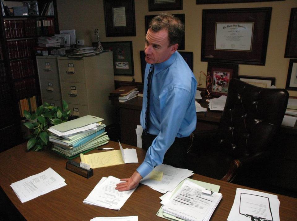 St. Petersburg attorney Matt Weidner pointing to mortgage foreclosure documents during his time as a foreclosure defense attorney.