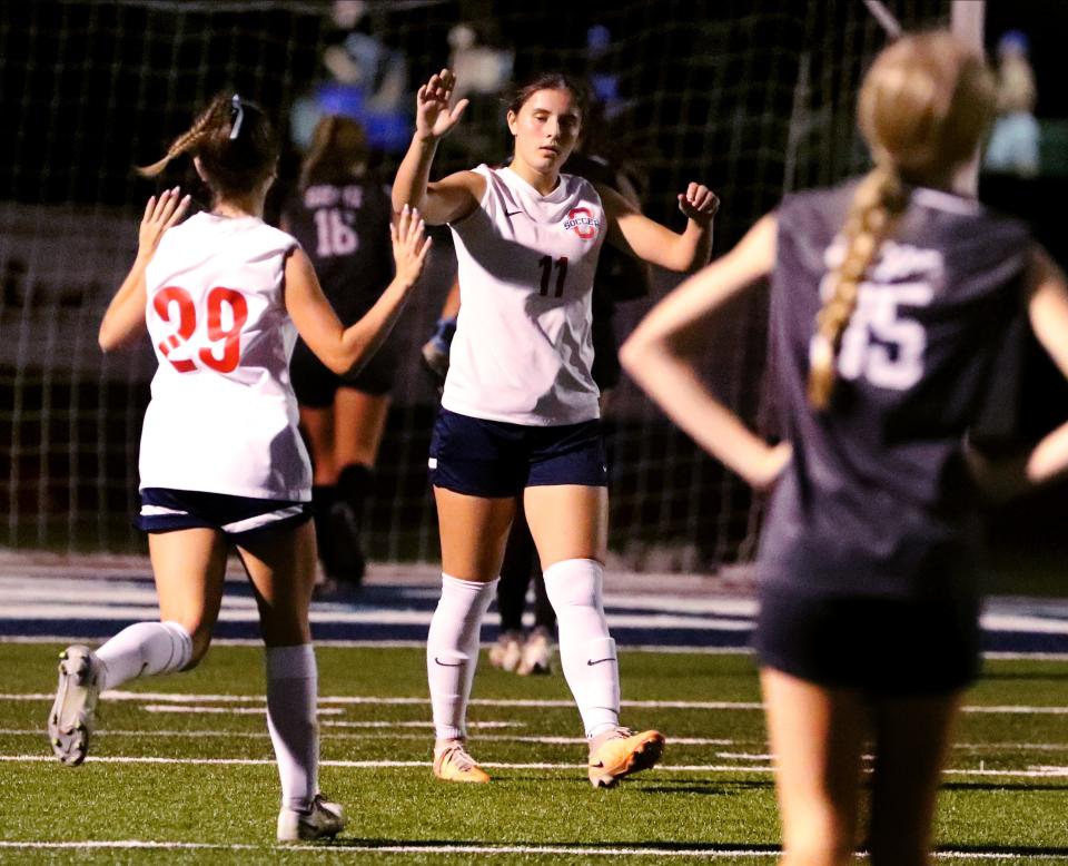 Oakland's Leah Krugh (11) celebrates her goal against Siegel with Oakland's Grace Cochran (29) as Siegel's Lilli Smith (35) reacts to the goal during a soccer game at Siegel on Tuesday, Sept, 26, 2023.