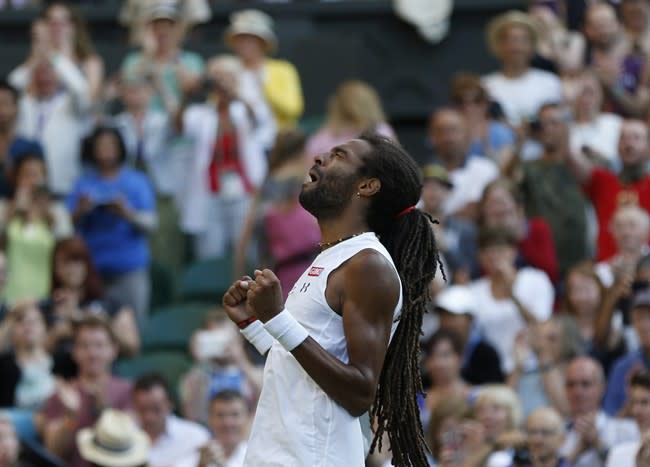 Dustin Brown of Germany, gestures after defeating Rafael Nadal of Spain, during their singles match, at the All England Lawn Tennis Championships in Wimbledon, London, Thursday July 2, 2015. (AP Photo/Pavel Golovkin)