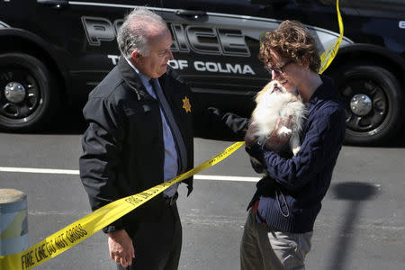 Burlingame police chief Eric Wollman hands off Kimba to his owner following an active shooter situation at YouTube headquarters. According to his owner, Kimba was present when the shooting occurred. REUTERS/Elijah Nouvelage