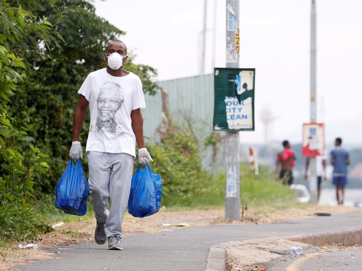 A man carries home groceries during a nationwide 21-day lockdown in an attempt to contain the coronavirus disease outbreak in Umlazi township near Durban, South Africa: Rogan Ward/Reuters